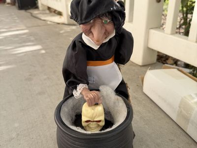 Animated Halloween Witch Stirring Cauldron with Light-Up Skull Prop