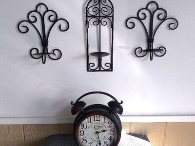 Wall decor metal candle holders and clock.