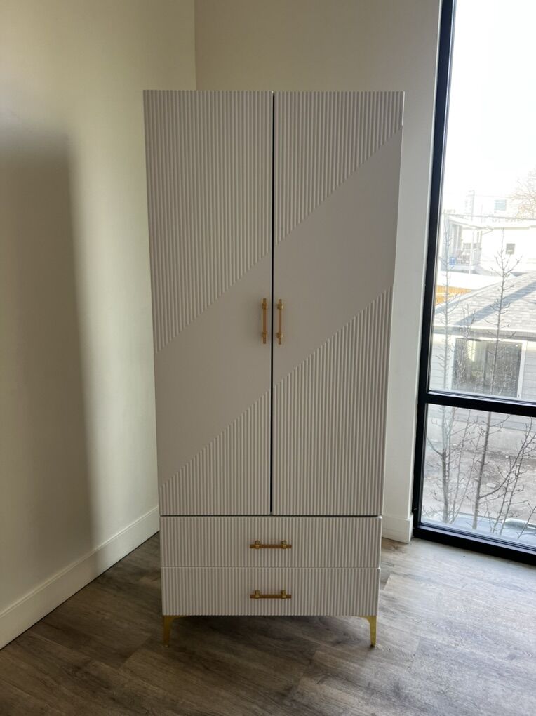 White armoire with gold hardware