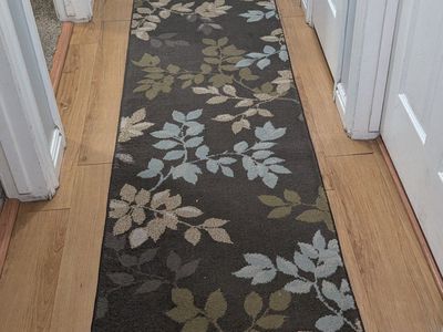 brown hallway rug with leaves runner