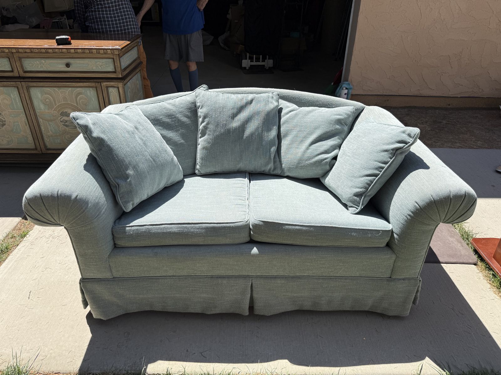 Light Blue Upholstered Loveseat with Rolled Arms and Matching Throw Pillows
