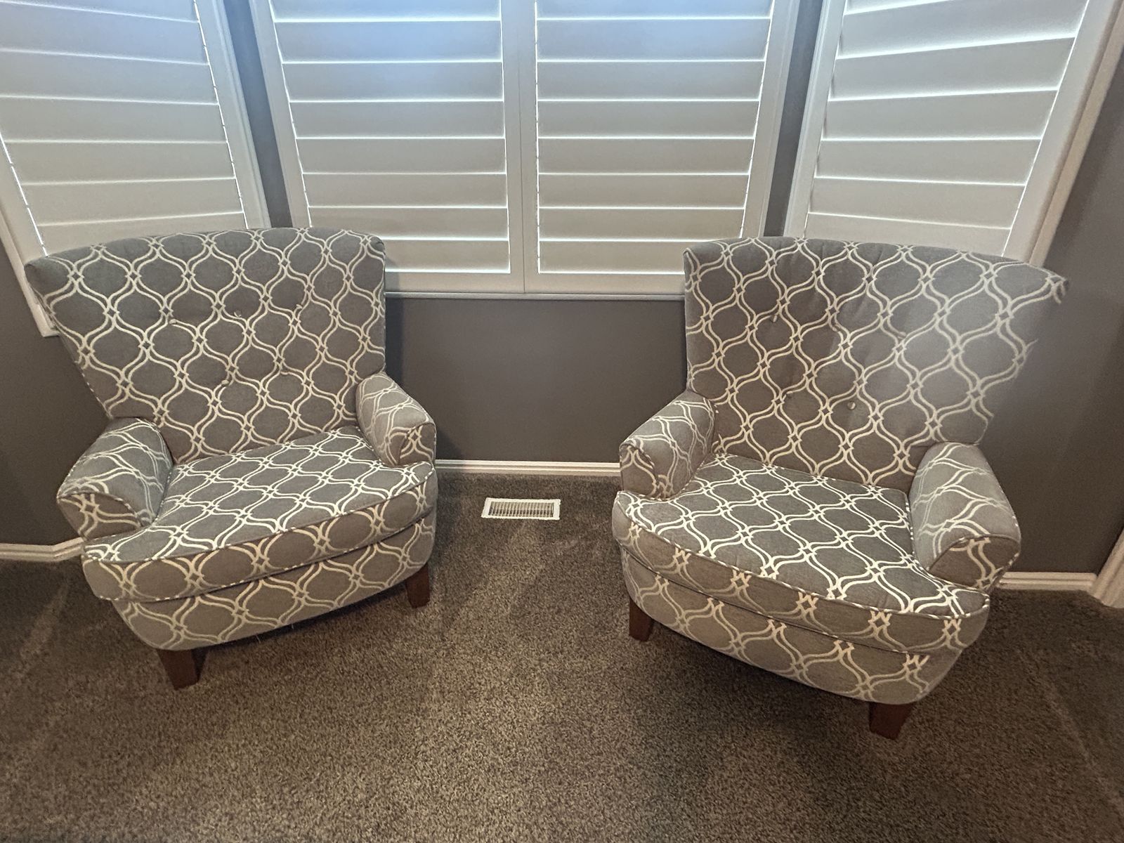 Pair of Gray & White Patterned Upholstered Armchairs and Floral Area Rug