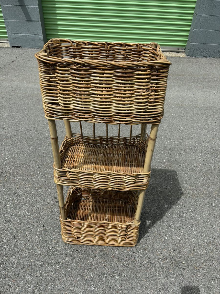 three-tier wicker or rattan basket shelf