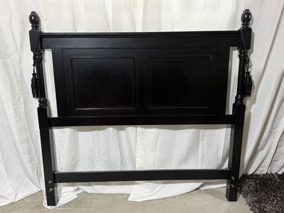 Black Wooden Headboard with Decorative Finials and Tassels
