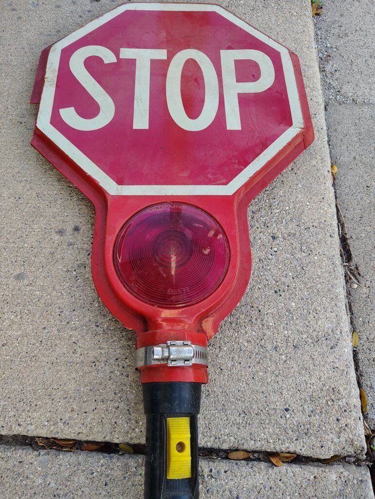 old flashlight crossing guard stop sign