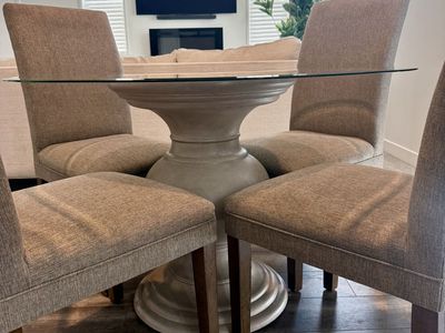 Glass Top Dining Table with Pedestal Base & 4 Upholstered Chairs