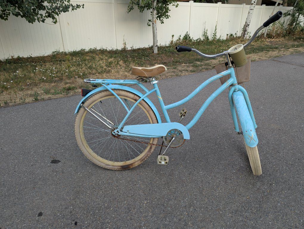 Light Blue Bicycle with Basket and Rear Rack