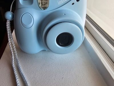 Blue Fuji film camera with film