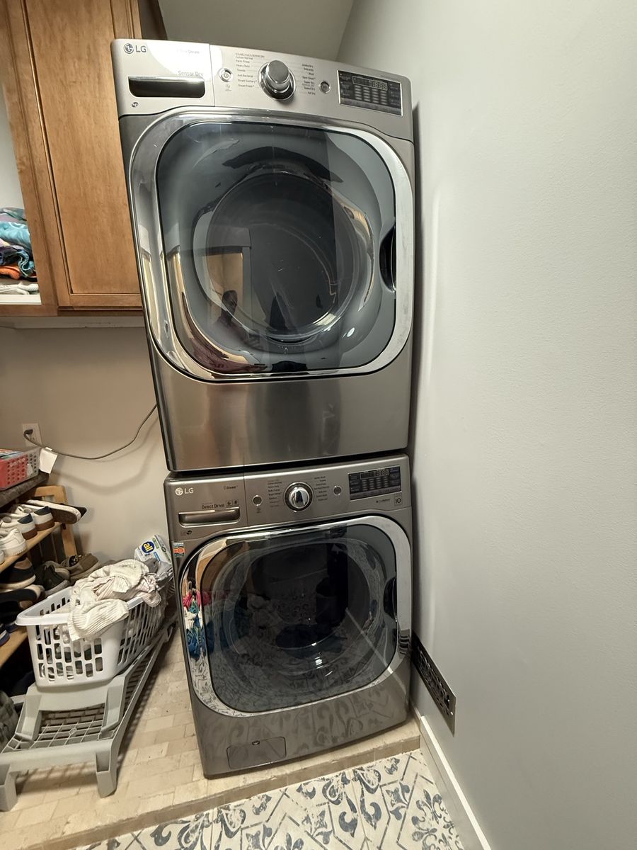 LG Front Load Washer and Dryer Set Stainless Steel Stackable. Dryer is Gas pedestals included.