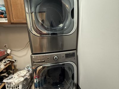 LG Front Load Washer and Dryer Set Stainless Steel Stackable. Dryer is Gas pedestals included.