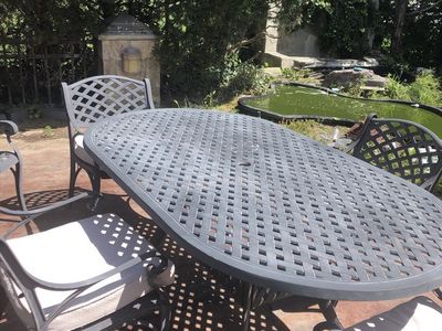 Oasis Oval Patio Dining Set: Table & 5 Chairs w/ Cushions & Covers