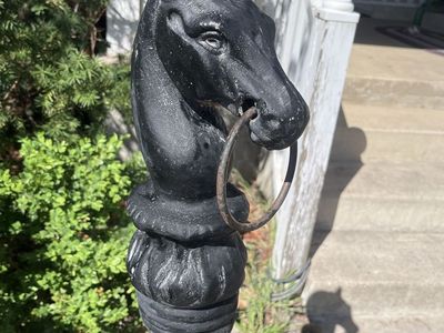 Antique horse head hitching post