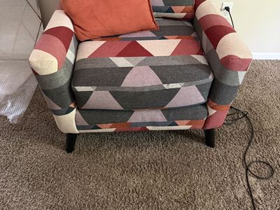 Geometric Pattern Accent Chair with Orange Throw Pillow