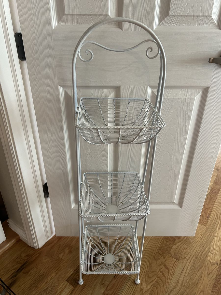 3 Tiered White Metal Basket Stand. Approximately 43” Tall, 10 1/2” Wide.