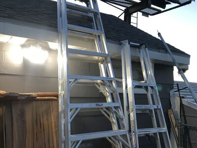 Two commercial warehouse ladders a 10 footer $200 and a 12 foot ladder with casters$250