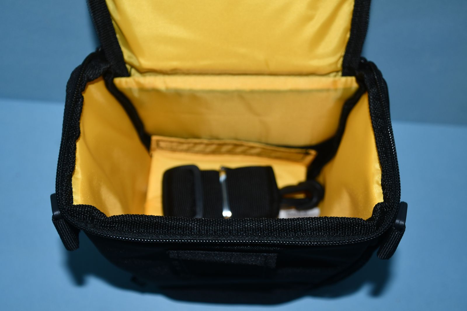 Universal triangle shaped holster style Camera bag with pockets.