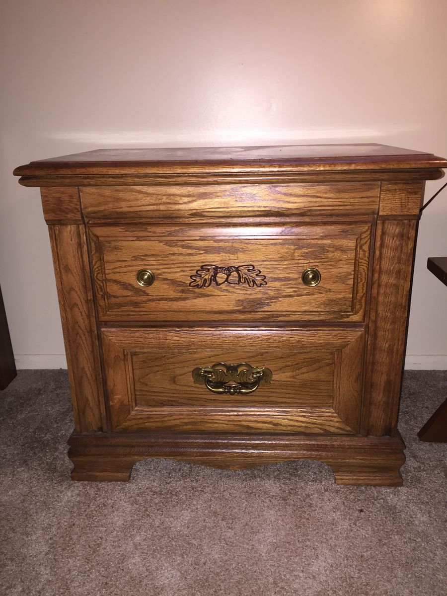 Oak Two-Drawer Nightstand with Brass Hardware and Carved Acorn Details