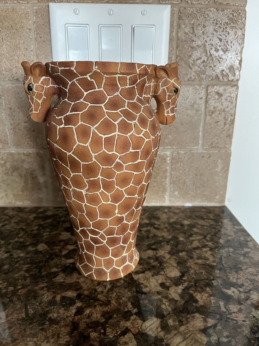 Vase that has two Giraffe heads on each side