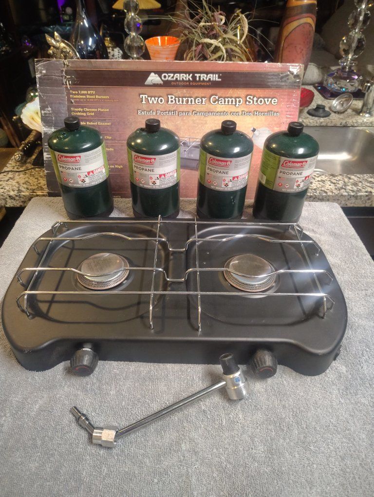 Selling a never-used Ozark Trail Two-Burner Camp Stove still in its original box.