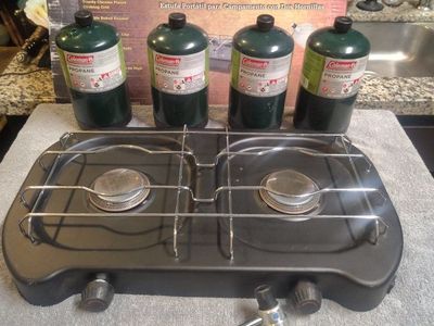 Selling a never-used Ozark Trail Two-Burner Camp Stove still in its original box.