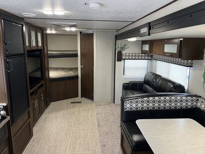 Spacious Travel Trailer with Bunk Beds, Sofa, and Dinette - Perfect for Family Adventures