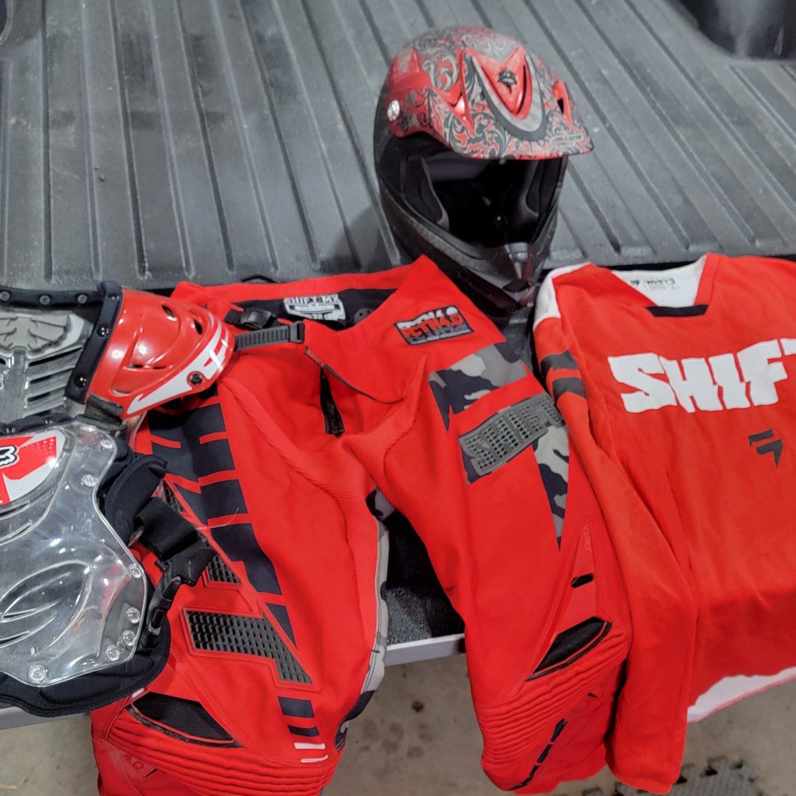 Dirt bike helmet, pants, shirt, chest protector
