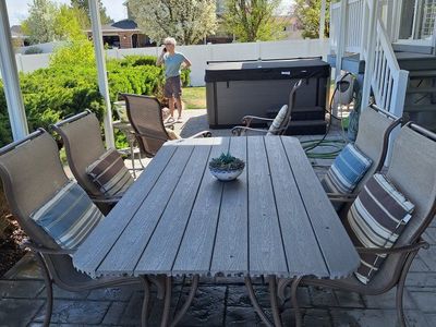 HUGE PATIO TABLE WITH 4 CHAIRS AND TWO SWIVEL ROCKERS
