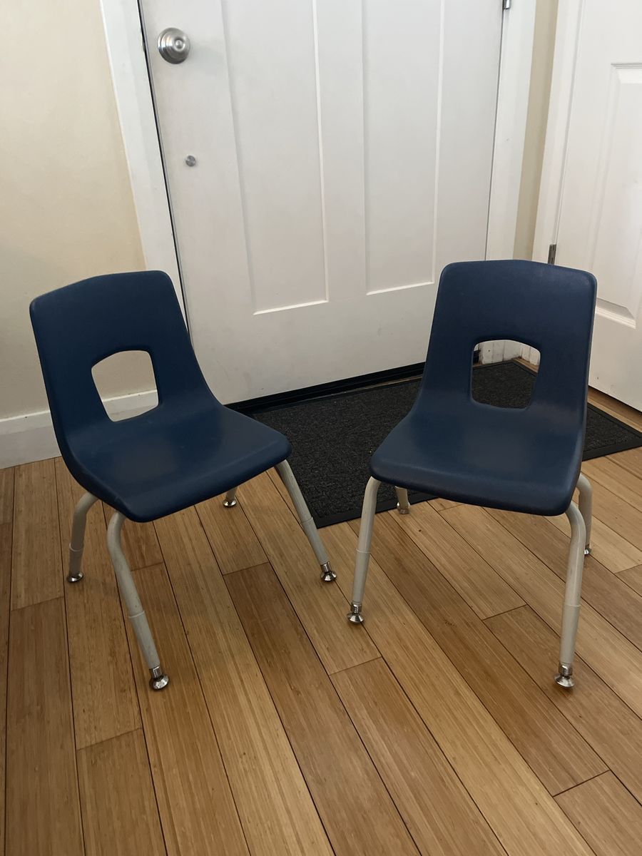 Two blue stackable kids chairs
