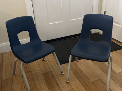 Two blue stackable kids chairs