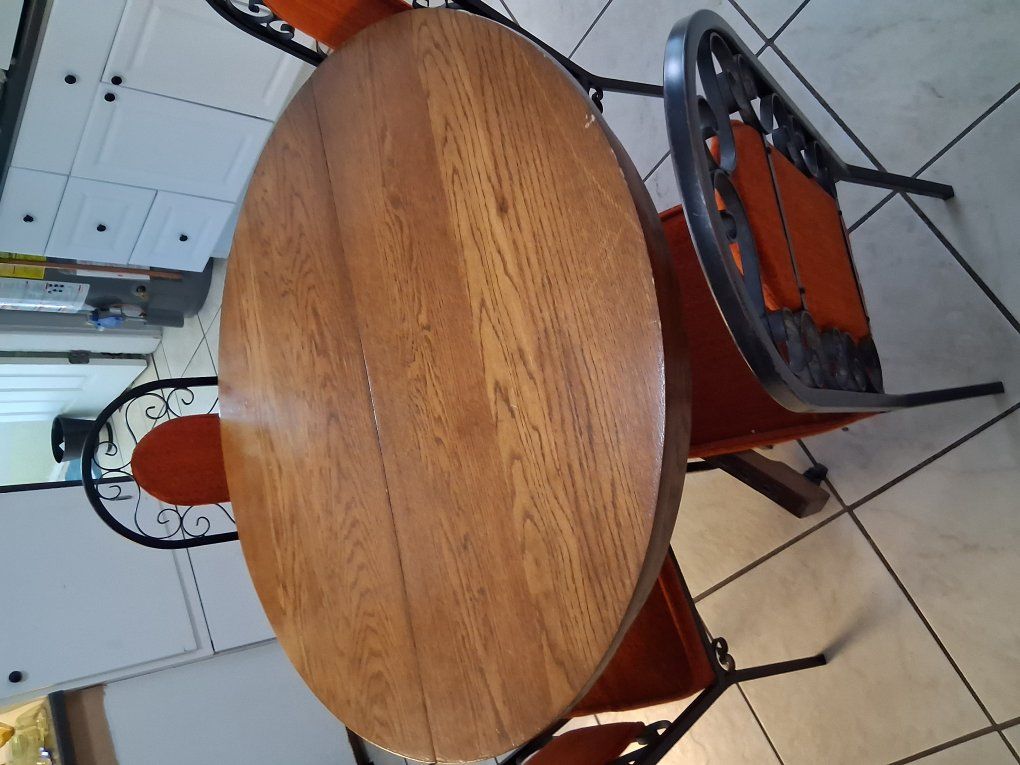 Round table with 4 wrought iron chairs sold as is