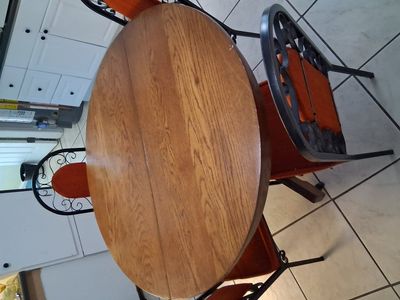 Round table with 4 wrought iron chairs sold as is