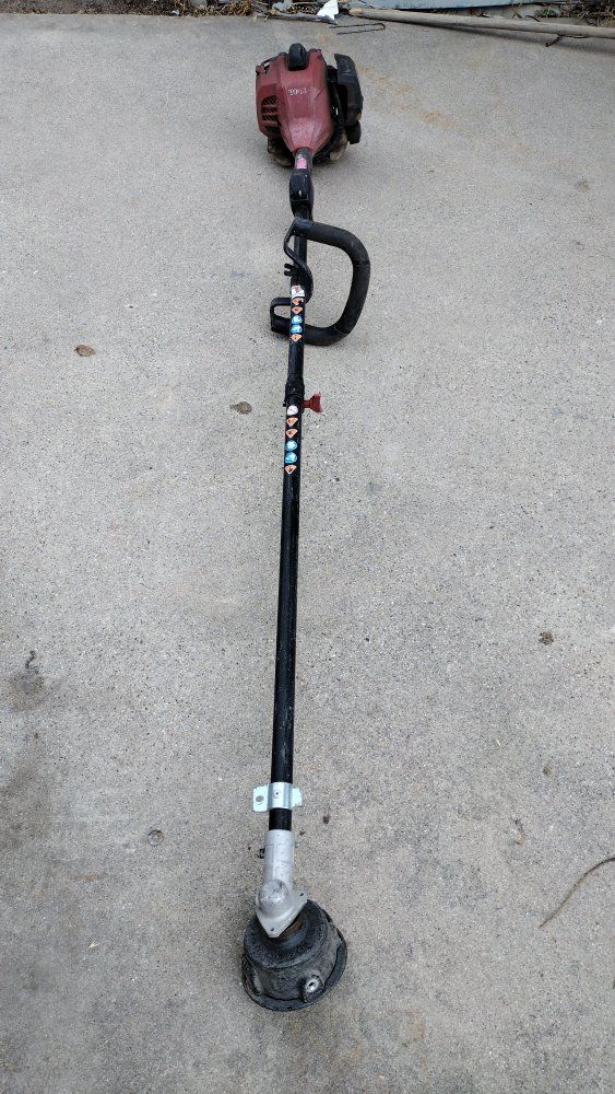 Toro weed eater. It doesn't work perfectly, but it gets the job done.
A piece of the trimmer head is missing (see pictures).