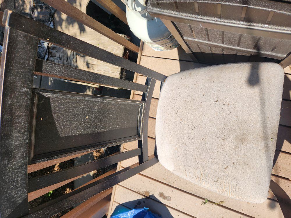 Two black wood chairs with padded seat