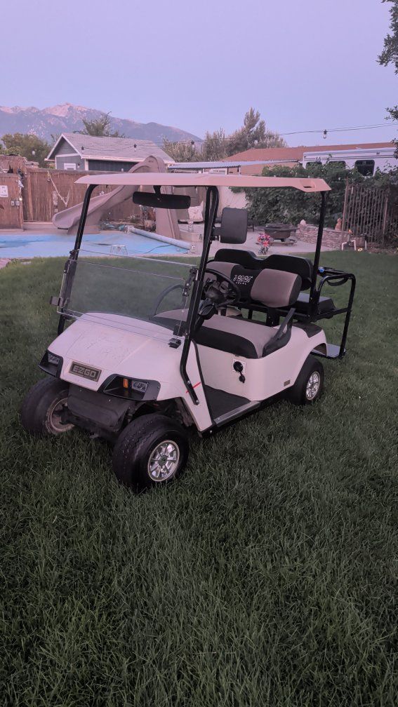 EZGO 4-Passenger Golf Cart with Roof, Folding Windshield & Rear Bench