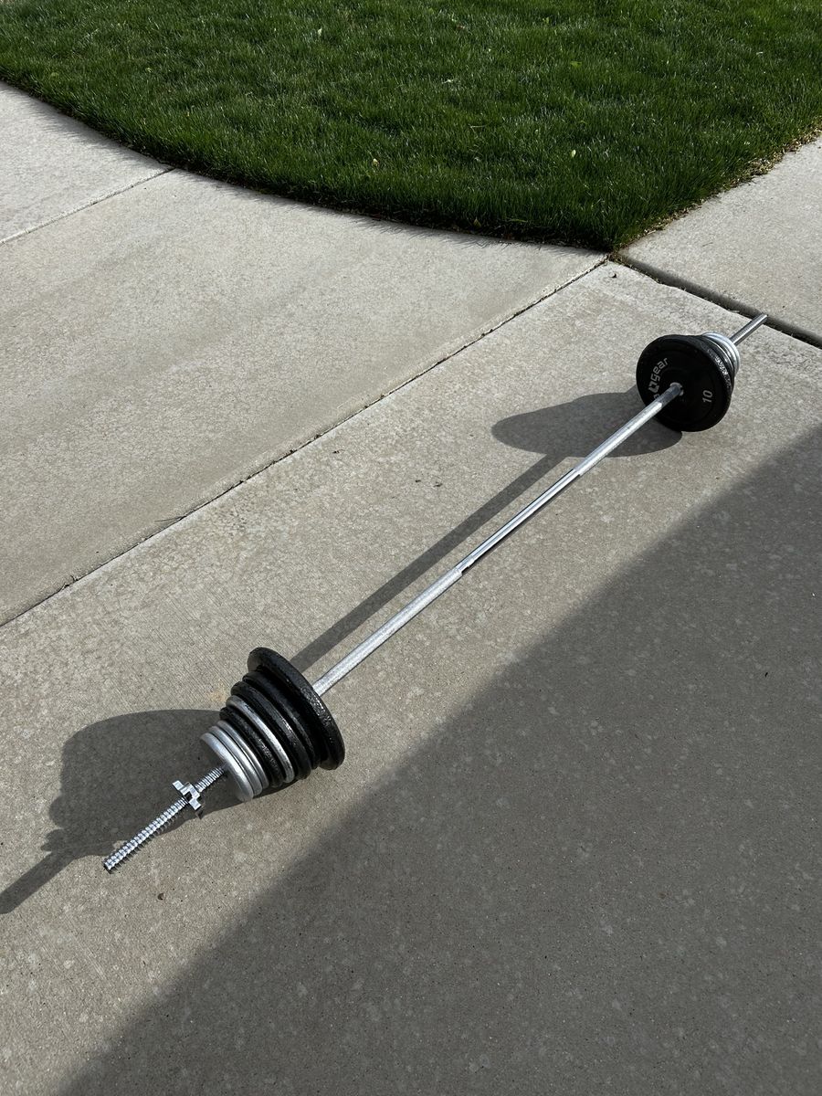 80 Pounds of Plate Weights Plus 5 Pound Bar