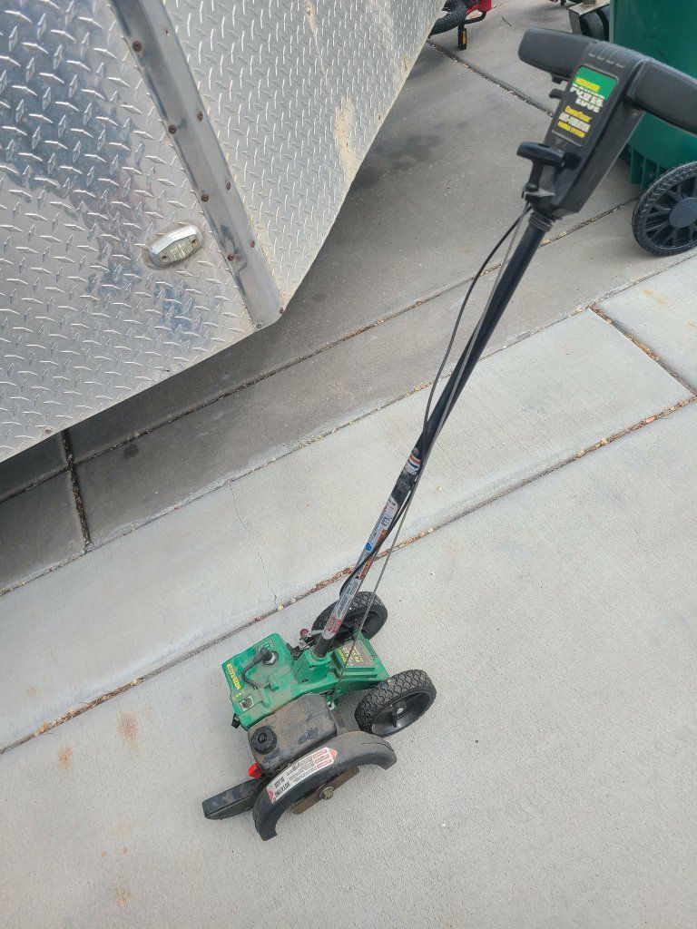 Gas powered lawn edger with blade