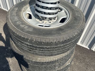 Four tires and rims off of factory 2023 GMC 2500.