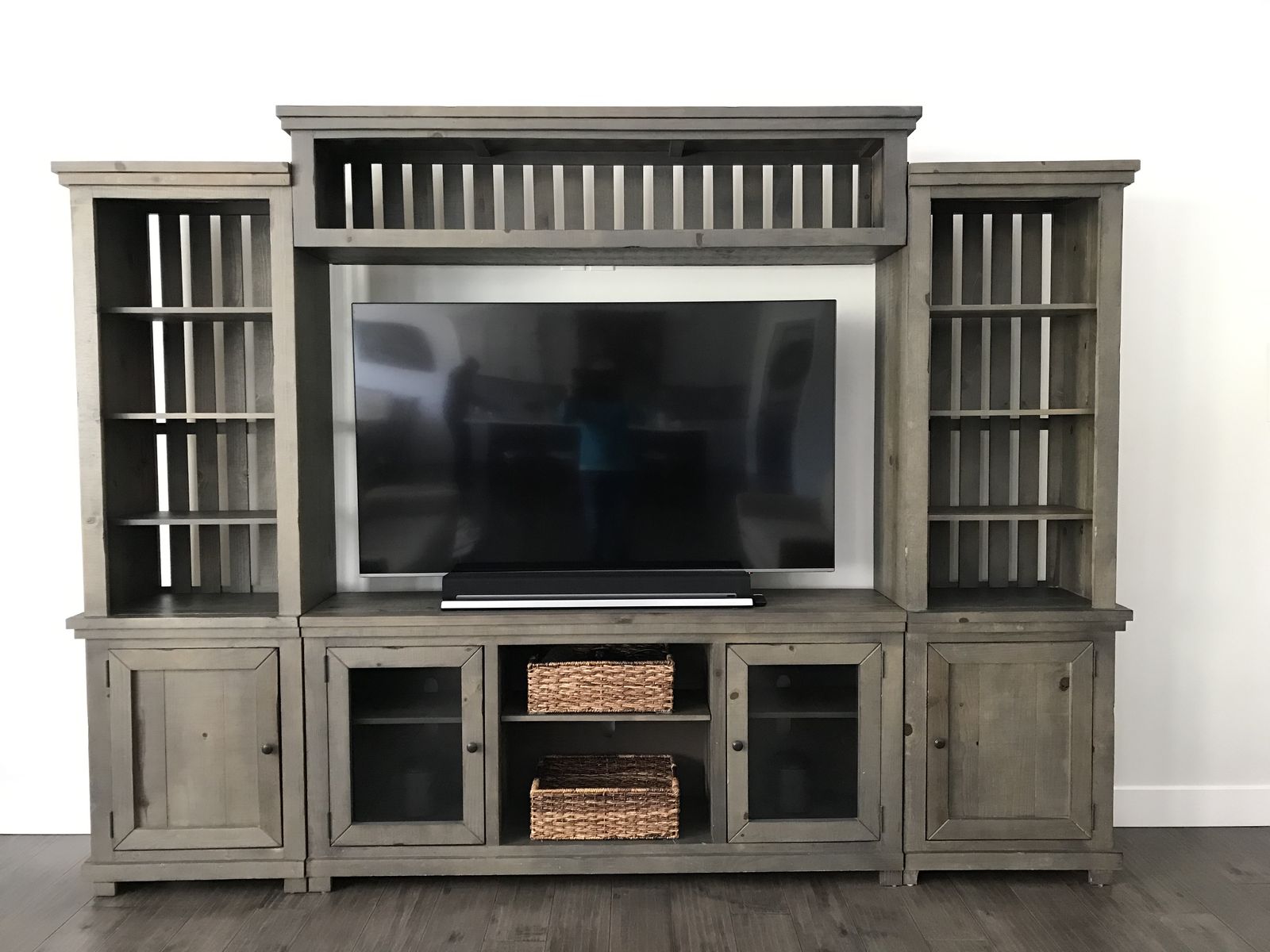 Smoke colored entertainment center 10ft wide, 88” high.