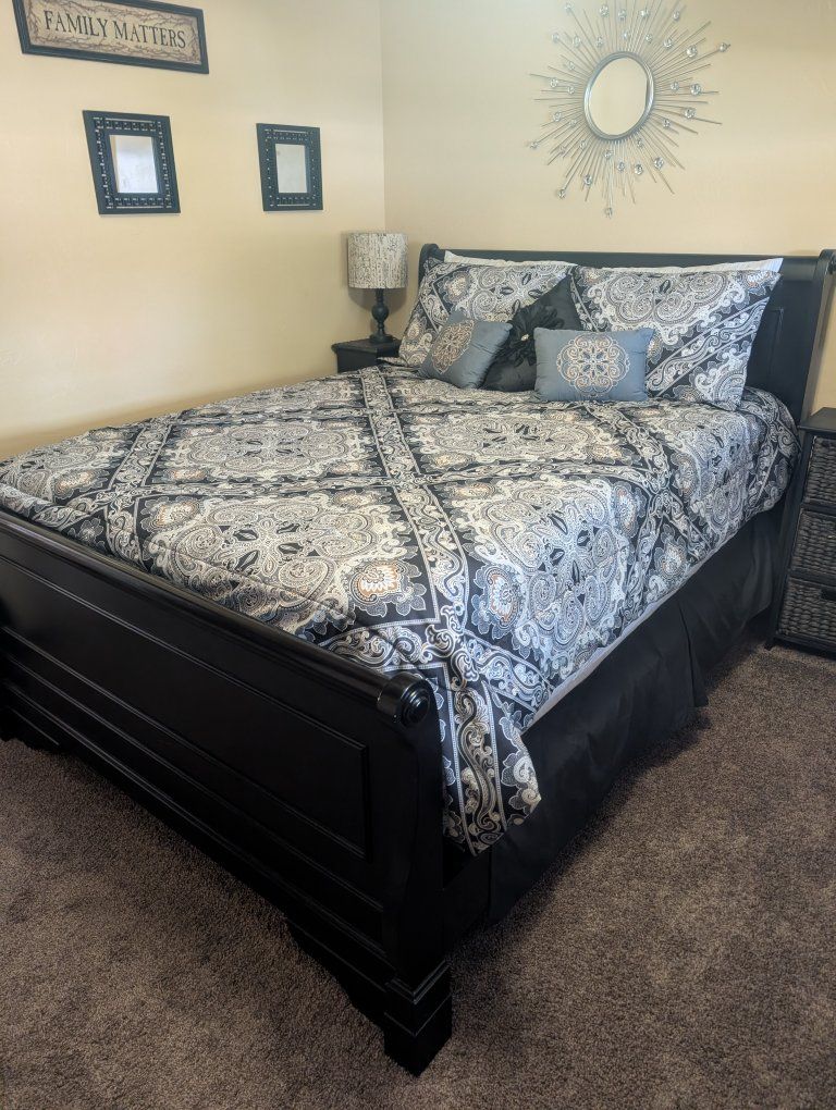 Dark Wood Sleigh Queen Bed Frame - Headboard, Footboard, Rails, Slats and clean mattress set.