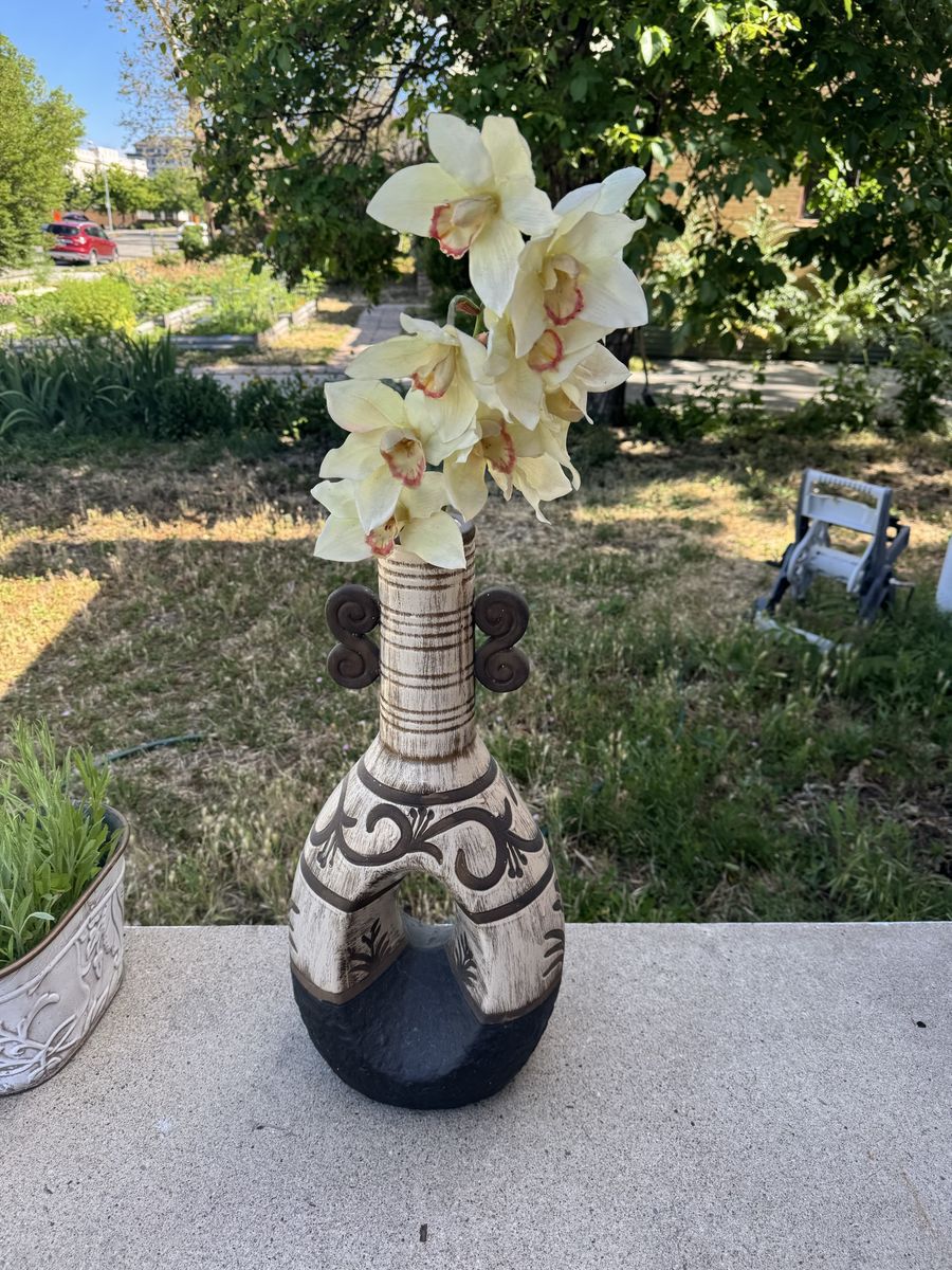 A decorative ceramic vase with a Southwest or boho-style design, 24” tall.