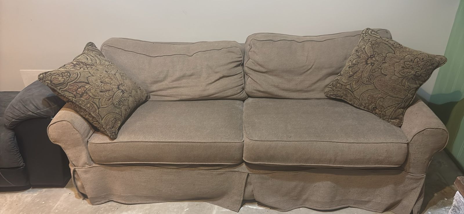 Used Beige Two-Seater Couch with Skirt and Throw Pillows