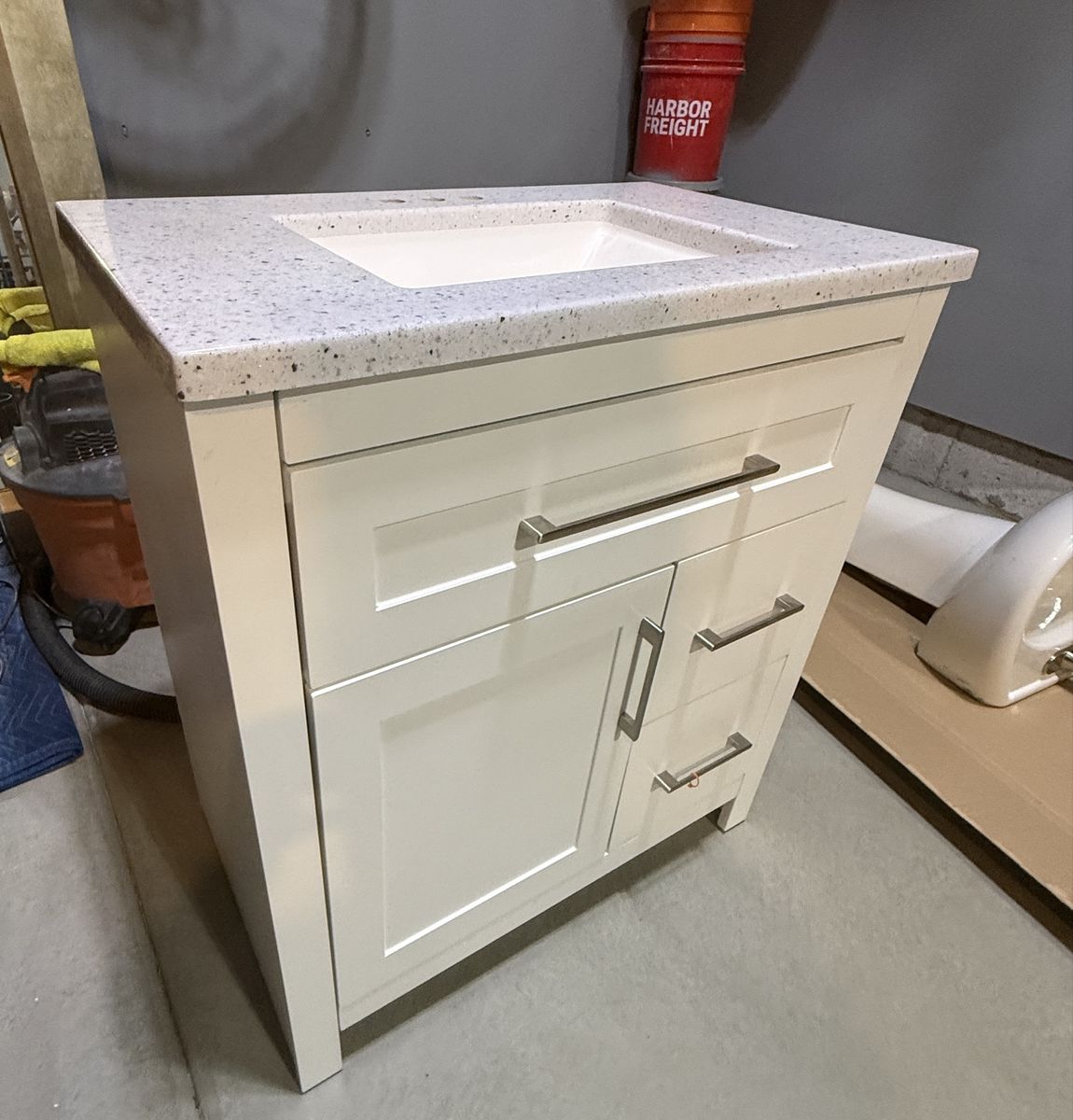 White Bathroom Vanity with White Speckled Countertop and Sink