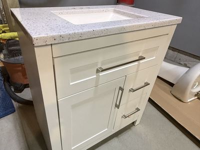 White Bathroom Vanity with White Speckled Countertop and Sink