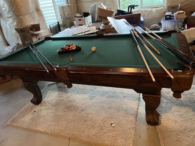 Pool table with pool sticks
