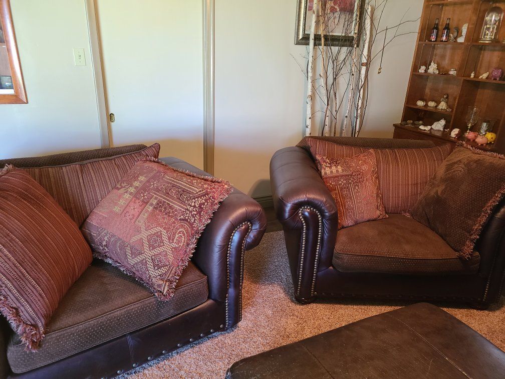 2 leather love seat with pillows