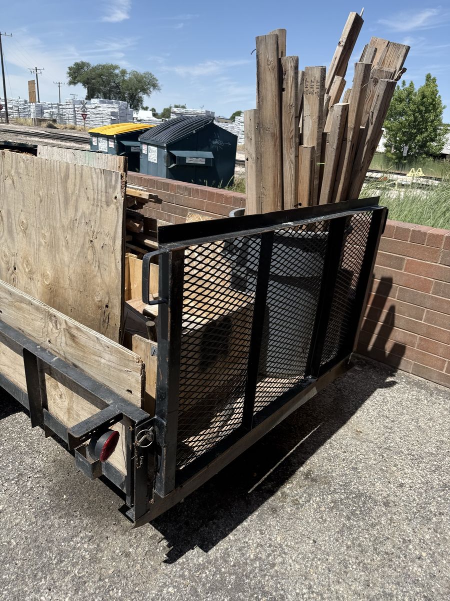 Single axle flat bed trailer with ramp.