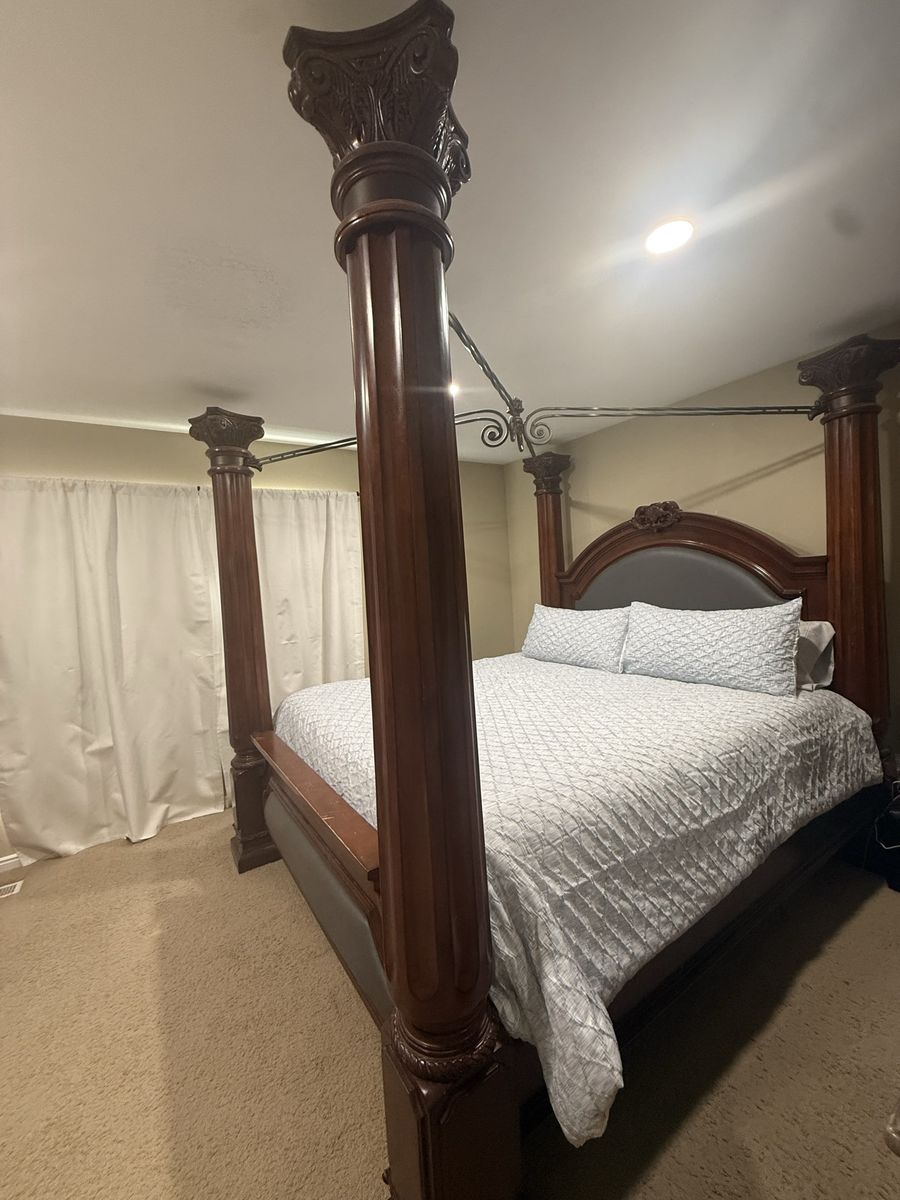 Grand Wooden Four Poster Canopy Bed with Carved Columns and Upholstered Headboard