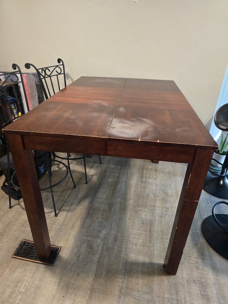 Extending Wooden Dining Table with Black Swivel Chairs