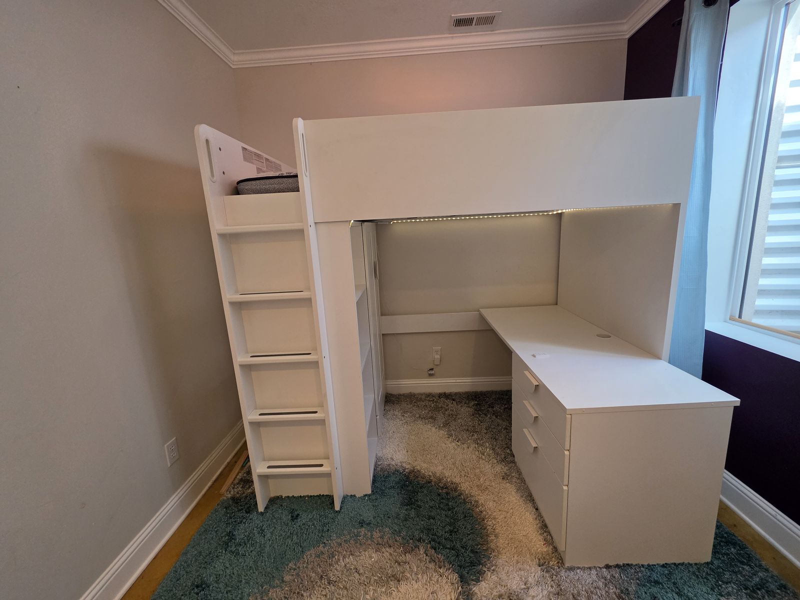 Ikea loft bed with desk, storage, and wardrobe