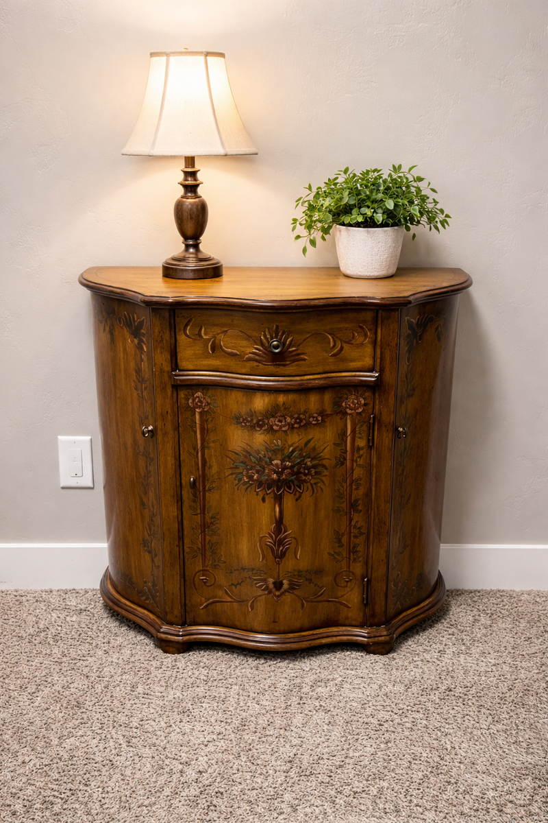 French Provincial cabinet with a beautiful curved (bombé) front and floral detailing.
